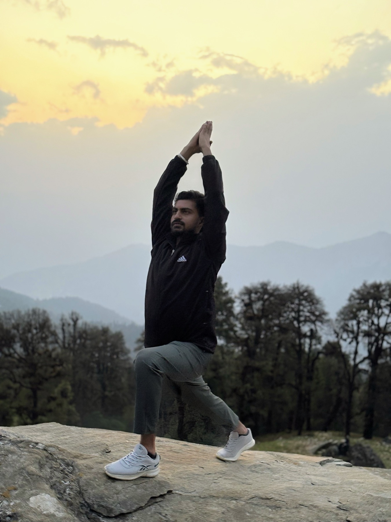 Utsavyogi.com practising yoga at sunrise in the mountains